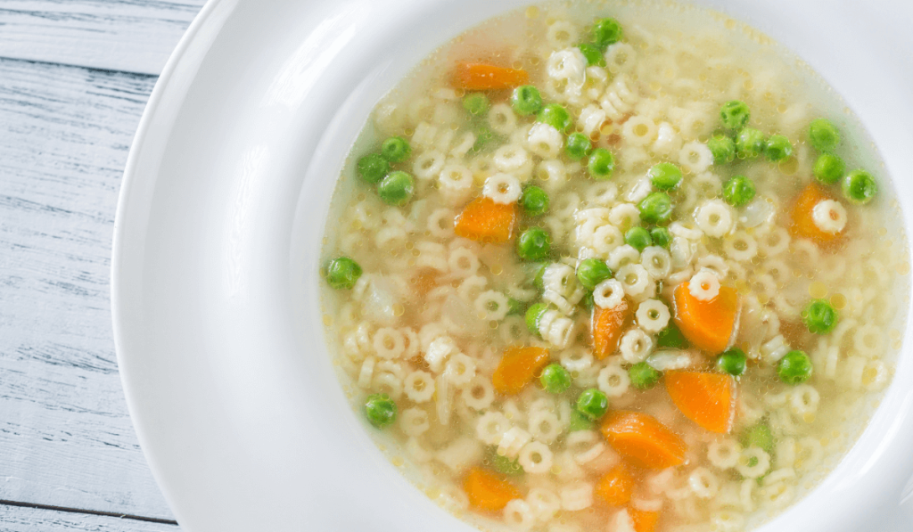 A green bowl filled with rice, perfect for a delectable pastina recipe.