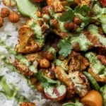 Cauliflower shawarma bowls topped with fresh vegetables and sauces