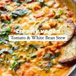 Creamy vegan tomato white bean stew served in a bowl with herbs